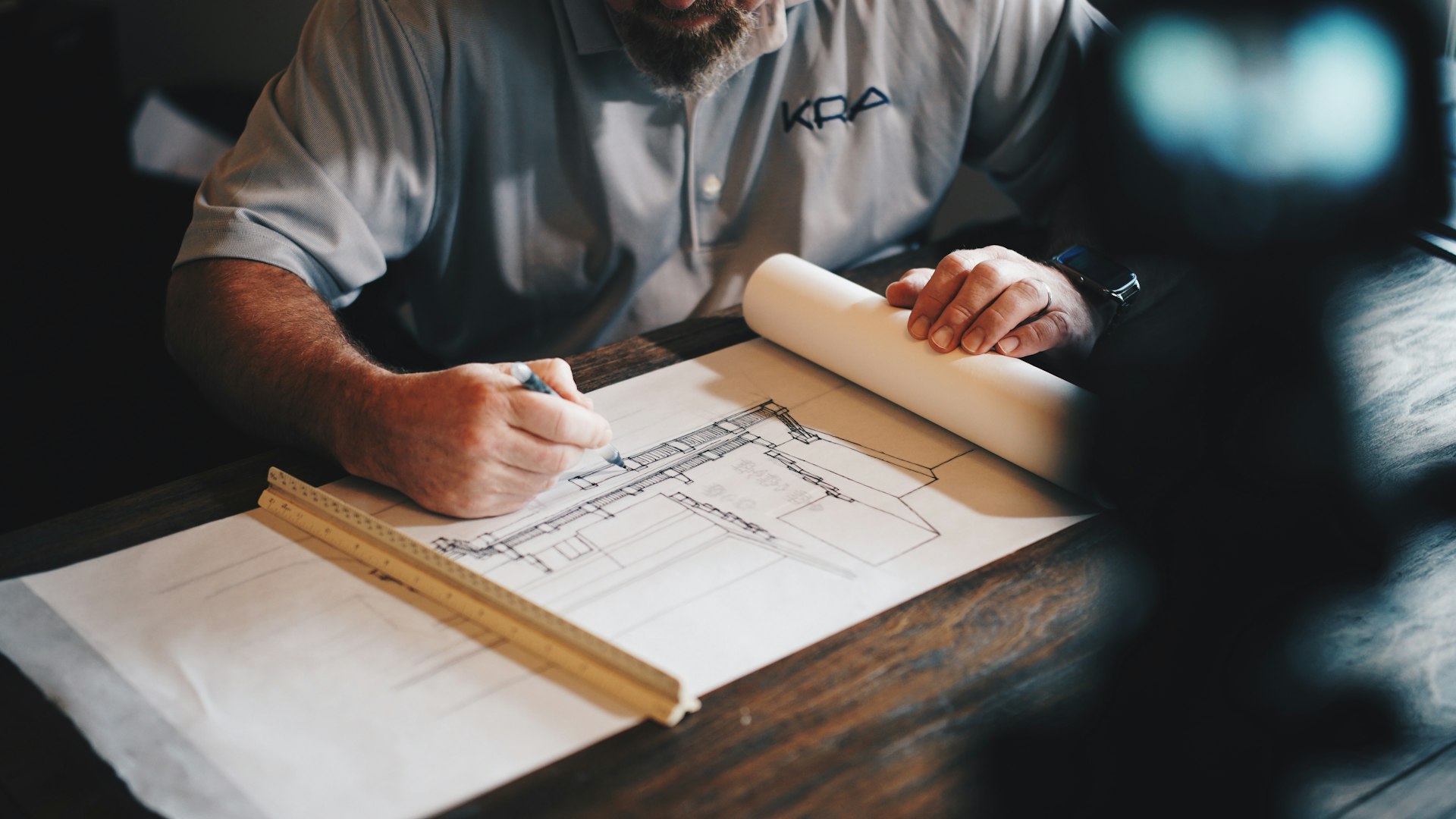 A builder marking up architectural drawings